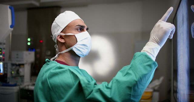 Surgeon Focusing on Digital Screen for Medical Procedure in Operating Room - Download Free Stock Images Pikwizard.com