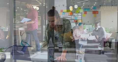 Composite image of office workers and businessman with laptop in modern office