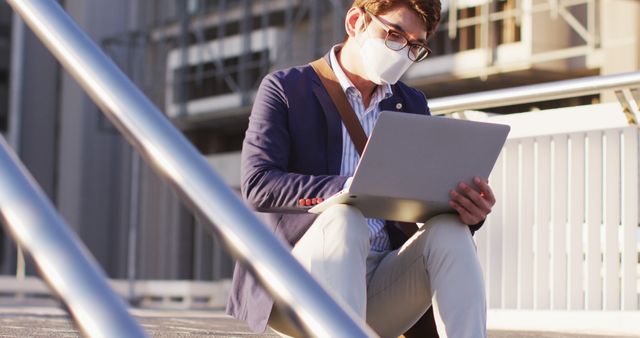 Businessman Wearing Mask Using Laptop Outdoors in Urban Area - Download Free Stock Images Pikwizard.com