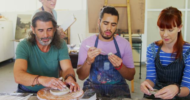 Diverse Group of People Sculpting Clay at Art Class - Download Free Stock Images Pikwizard.com