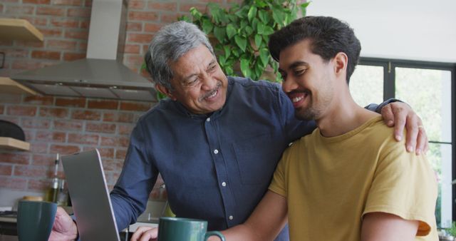 Elder Father Bonding with Adult Son at Home Using Laptop - Download Free Stock Images Pikwizard.com