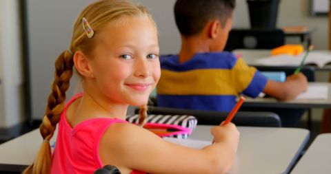 Smiling Schoolgirl Learning in Vibrant Classroom - Download Free Stock Images Pikwizard.com