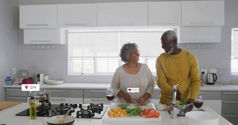 Senior Couple Joyously Cooking Together in Modern Kitchen