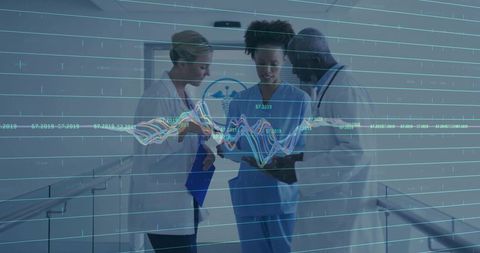 Medical team analyzing data in hospital corridor with technology integration