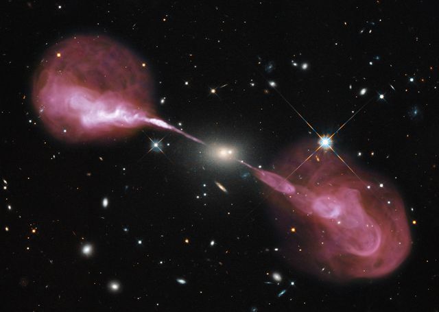 Spectacular jets powered by the gravitational energy of a super massive black hole in the core of the elliptical galaxy Hercules A illustrate the combined imaging power of two of astronomy's cutting-edge tools, the Hubble Space Telescope's Wide Field Camera 3, and the recently upgraded Karl G. Jansky Very Large Array (VLA) radio telescope in New Mexico.  <b>To view a video of this go to: <a href="http://bit.ly/Ue2ypS" rel="nofollow">bit.ly/Ue2ypS</a> </b>  Some two billion light-years away, the yellowish elliptical galaxy in the center of the image appears quite ordinary as seen by Hubble in visible wavelengths of light. The galaxy is roughly 1,000 times more massive than the Milky Way and harbors a 2.5-billion-solar-mass central black hole that is 1,000 times more massive than the black hole in the Milky Way. But the innocuous-looking galaxy, also known as 3C 348, has long been known as the brightest radio-emitting object in the constellation Hercules. Emitting nearly a billion times more power in radio wavelengths than our Sun, the galaxy is one of the brightest extragalactic radio sources in the entire sky.  Credit: NASA, ESA, S. Baum and C. O'Dea (RIT), R. Perley and W. Cotton (NRAO/AUI/NSF), and the Hubble Heritage Team (STScI/AURA)  To read more about this image go to: <a href="http://1.usa.gov/Yu7uvX" rel="nofollow">1.usa.gov/Yu7uvX</a>  <b><a href="http://www.nasa.gov/audience/formedia/features/MP_Photo_Guidelines.html" rel="nofollow">NASA image use policy.</a></b>  <b><a href="http://www.nasa.gov/centers/goddard/home/index.html" rel="nofollow">NASA Goddard Space Flight Center</a></b> enables NASA’s mission through four scientific endeavors: Earth Science, Heliophysics, Solar System Exploration, and Astrophysics. Goddard plays a leading role in NASA’s accomplishments by contributing compelling scientific knowledge to advance the Agency’s mission.  <b>Follow us on <a href="http://twitter.com/NASA_GoddardPix" rel="nofollow">Twitter</a></b>  <b>Like us on <a href="http://www.facebook.com/pages/Greenbelt-MD/NASA-Goddard/395013845897?ref=tsd" rel="nofollow">Facebook</a></b>  <b>Find us on <a href="http://instagram.com/nasagoddard?vm=grid" rel="nofollow">Instagram</a></b>