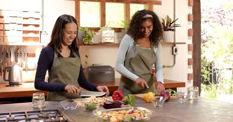 Friends enjoying cooking together in rustic kitchen