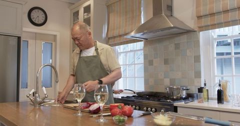 Senior Man Preparing Fresh Meal in Bright Home Kitchen