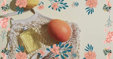 Floral border with orange and bottle in mesh bag on light background