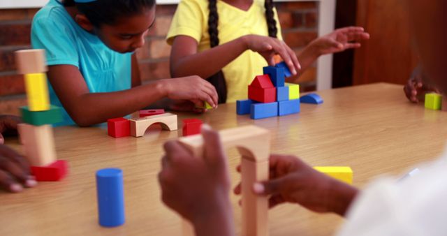 Pupils playing with building blocks in classroom in elementary school