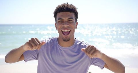 Joyful Young Man Celebrating at Sunny Beach