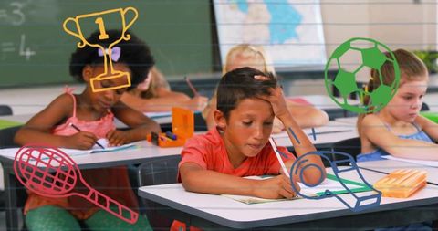 Elementary students concentrating and writing during classroom learning with sports icons