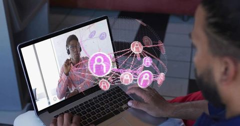 Typing man leaning over laptop with pink ar collaboration overlay for remote conference