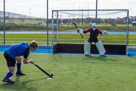 Field hockey match in action on sunny day