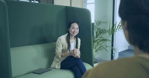 Professional Woman Holding Mug in Modern Lounge Interior