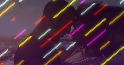 Romantic silhouetted couple leaning foreheads on golden shoreline with neon streak overlays