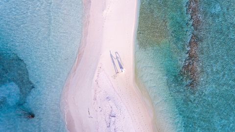 Aerial View of Serene Beach with Calm Azure Waters