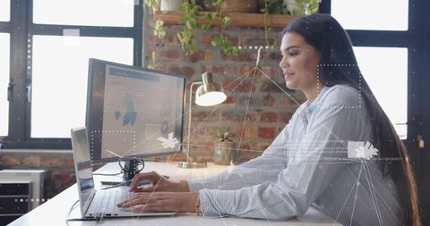 Professional Woman Analyzing Data in Loft Office Workspace