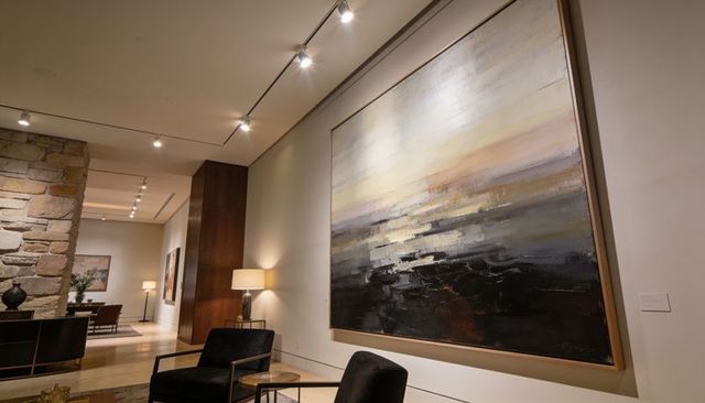 Contemporary living room gallery featuring oversized abstract canvas with neutral palette
