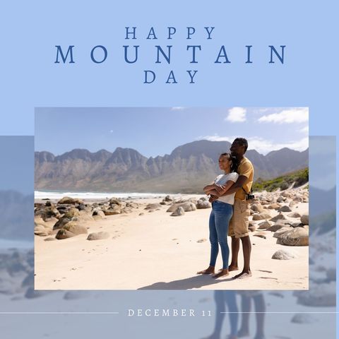 Mixed-Race Couple Embracing on Beach with Mountains in Background