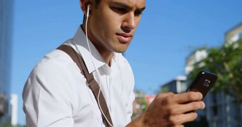 Young Male Professional Engaged in Smartphone in Urban Setting