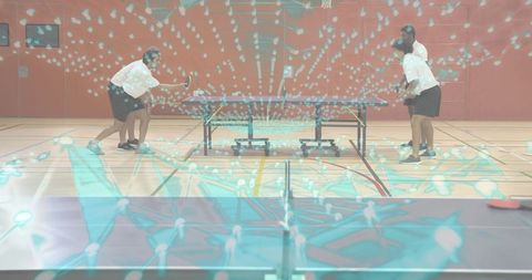 Four men playing doubles table tennis with turquoise network overlay in indoor gymnasium