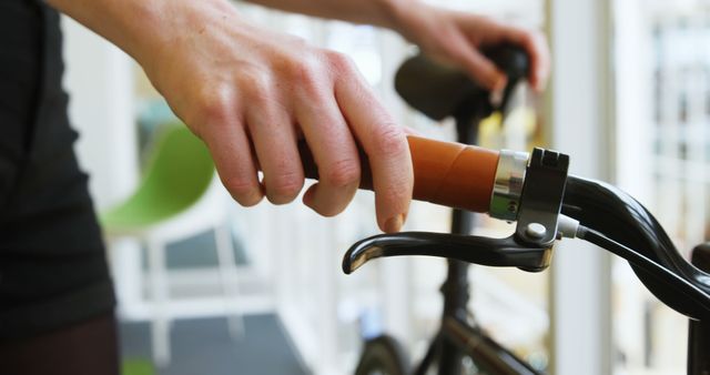 Hand Gripping Bicycle Handlebar in Modern Indoor Setting - Download Free Stock Images Pikwizard.com