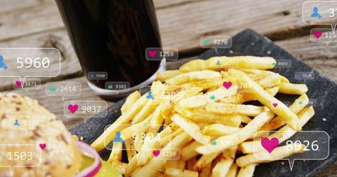 Crispy seasoned french fries on slate platter with burger bun and social media reactions