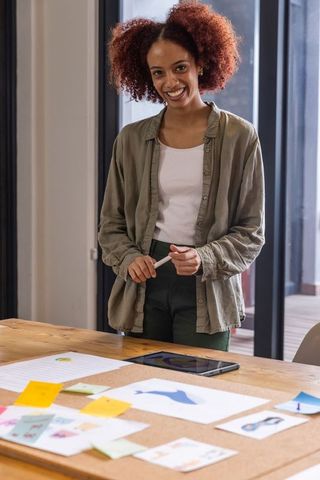 Creative African American Designer Smiling at Studio Workspace