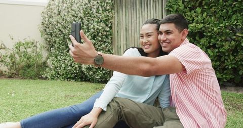 Young Couple Taking Selfie While Relaxing in Garden