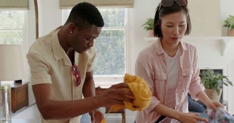 Couple Packing for Vacation in Bright Living Room
