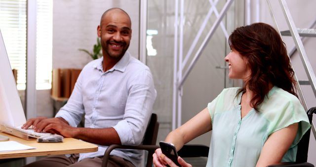 Colleagues Interacting in Inclusive Office Space - Download Free Stock Images Pikwizard.com