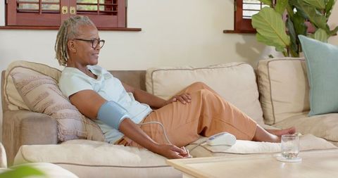 Senior woman monitoring blood pressure at home relaxation