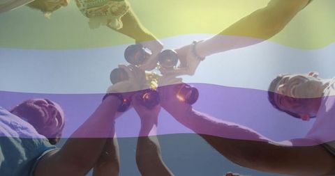 Friends Celebrating Outdoors with Beer Bottles Under Blue Sky