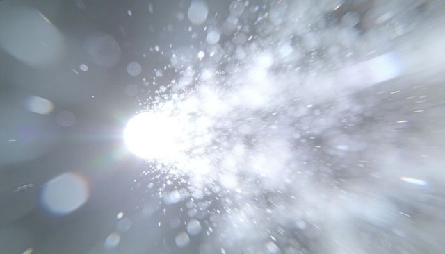 Exploding light burst scattering fine particles with dramatic bokeh and lens flare
