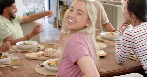 Young Friends Enjoying Lively Meal at Home