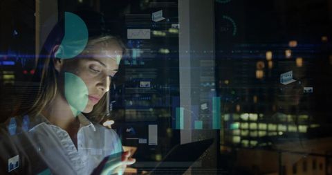 Businesswoman analyzing data on tablet in modern office at night