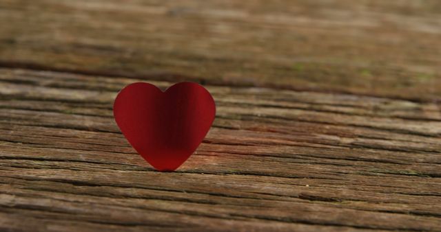 Red heart tuck in the wooden plank. Valentines day concept 4k