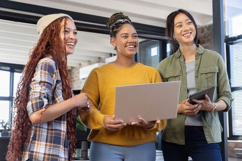 Female Coworkers Collaborating in Modern Office