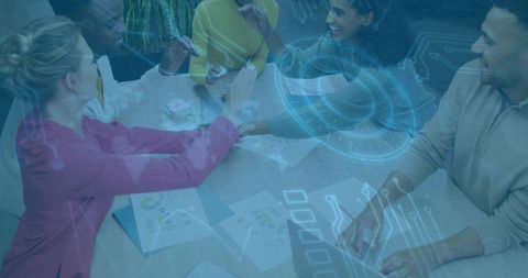 Diverse team collaborating over holographic data and digital strategy in modern office