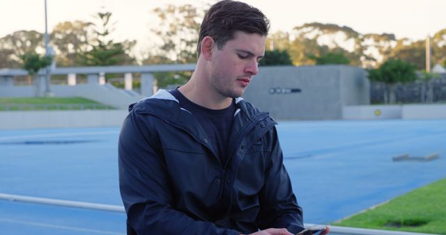 Young Man in Athletic Wear Using Smartphone Outdoor - Download Free Stock Images Pikwizard.com