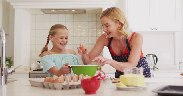 Caucasian mother and daughter baking together in the kitchen at home. family, love and togetherness concept