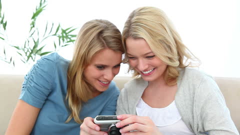 Happy Friends Taking Selfies at Home on Couch