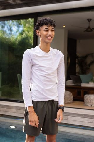 Young Man Enjoying Outdoor Relaxation by Modern Poolside