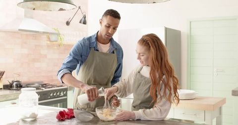 Diverse Couple Collaborating in Modern Kitchen Baking