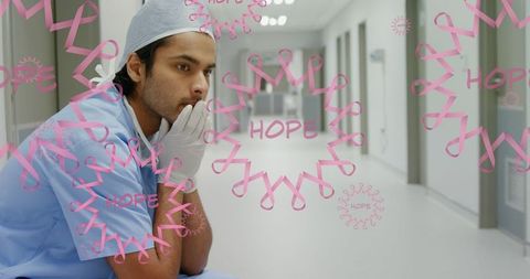 Pensive Surgeon with Inspirational Breast Cancer Awareness Imagery