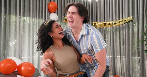 Joyful couple celebrating birthday together at home