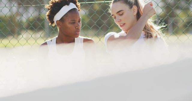 Two Female Tennis Players Taking a Break on Bench by Tennis Court - Download Free Stock Images Pikwizard.com