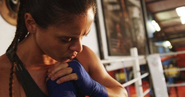 Focused Female Boxer Wrapping Hands in Training Gym - Download Free Stock Images Pikwizard.com