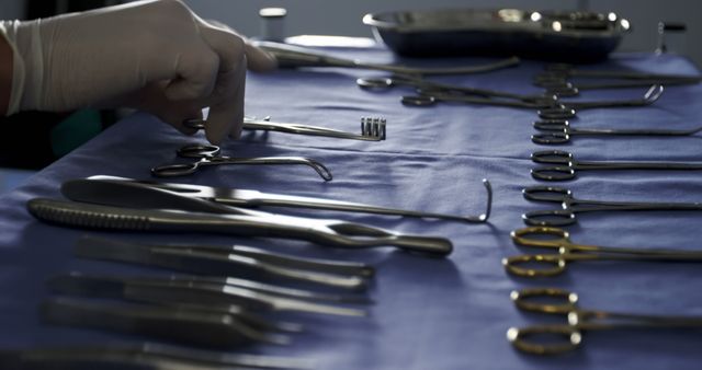 Close-up of surgeon arranging surgical tools on tray in operation room at the hospital