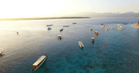 Transparent waters at sunset with boats on crystal clear lake